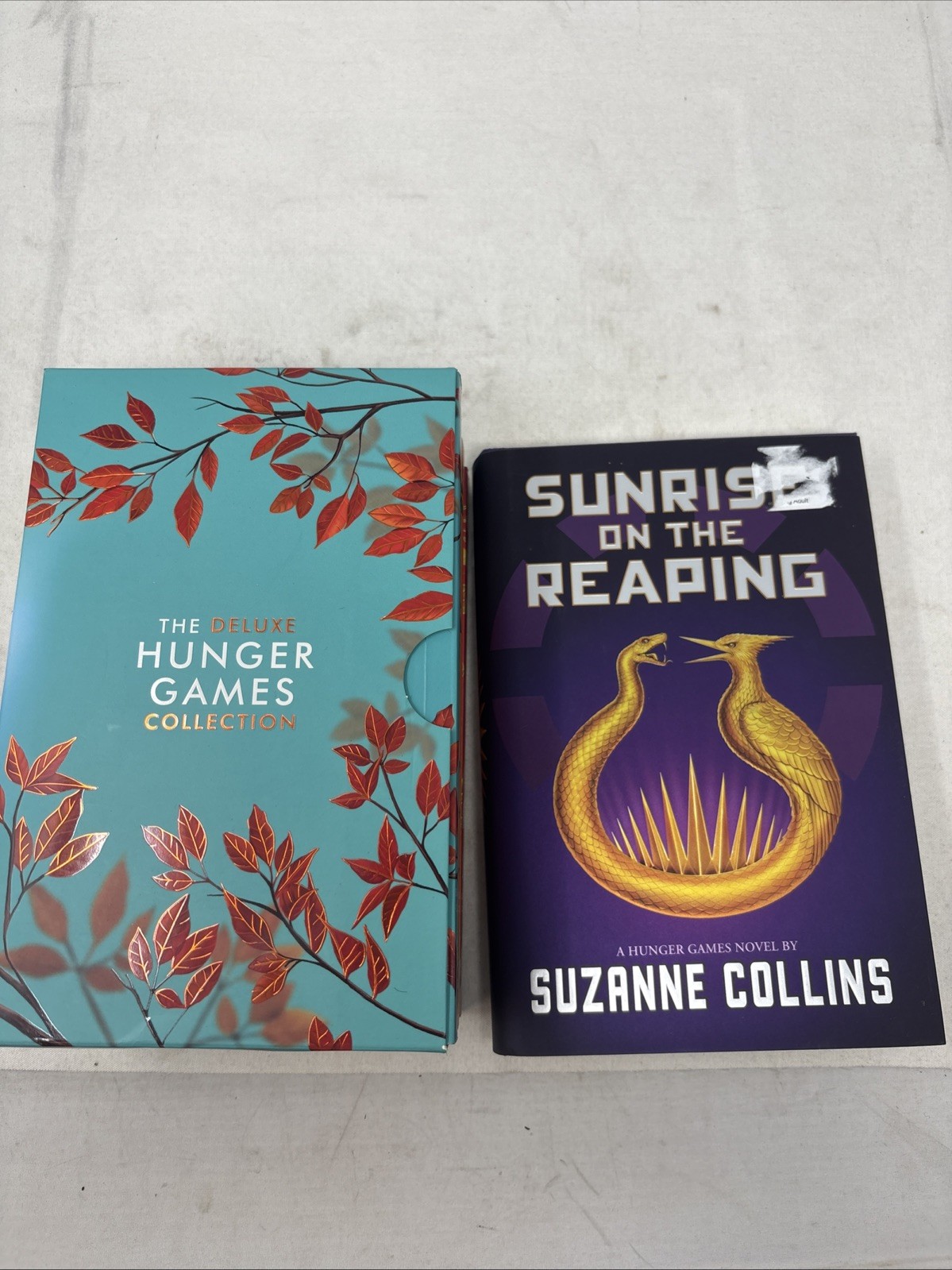 The Deluxe Hunger Games collection paperback + hard cover sunrise on the reaping