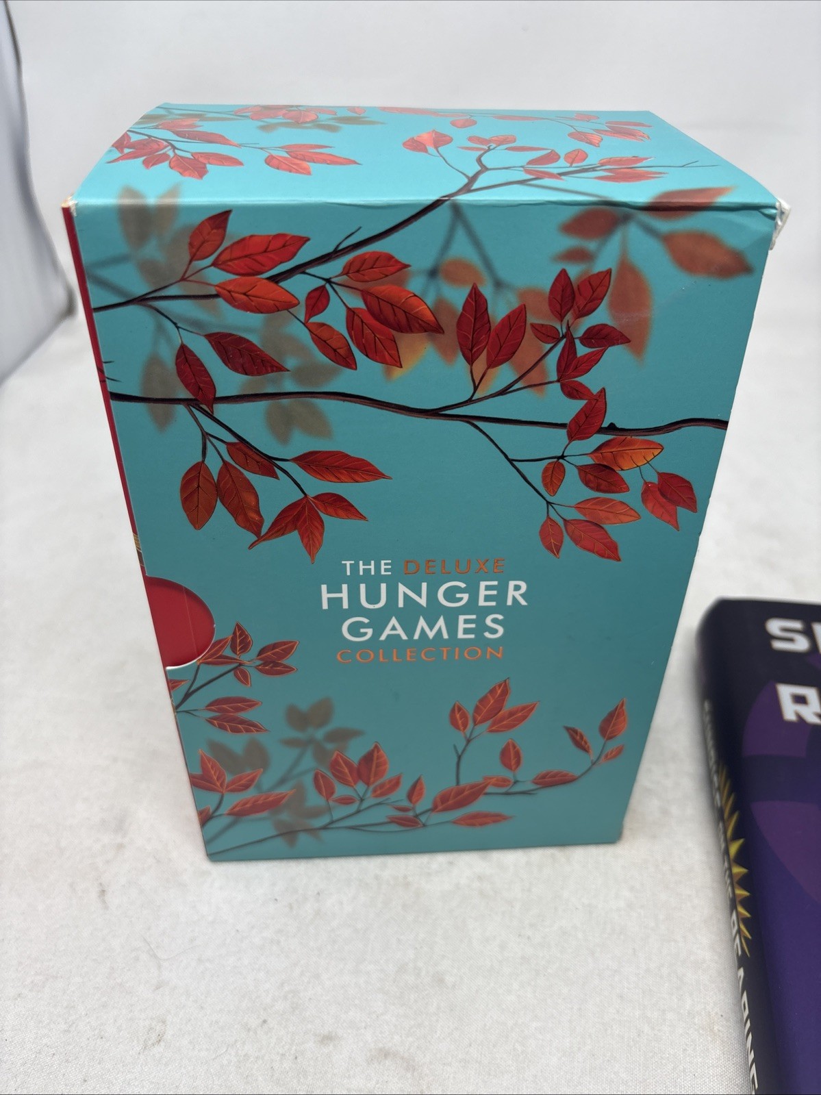 The Deluxe Hunger Games collection paperback + hard cover sunrise on the reaping
